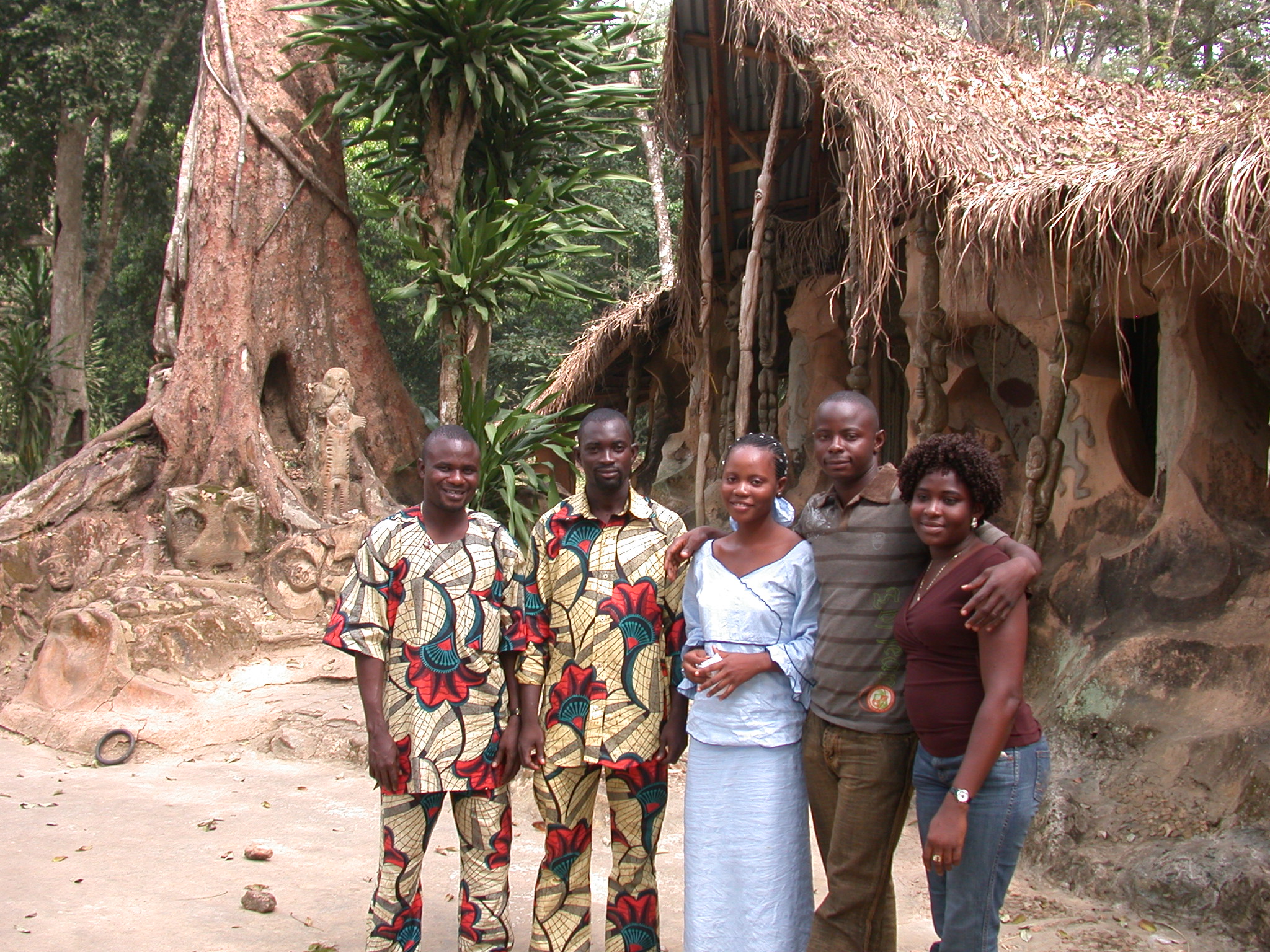 Nigerian Tourists in Front of Thatched Ceremonial Home, Osun Sacred Grove, Oshogbo, Nigeria
